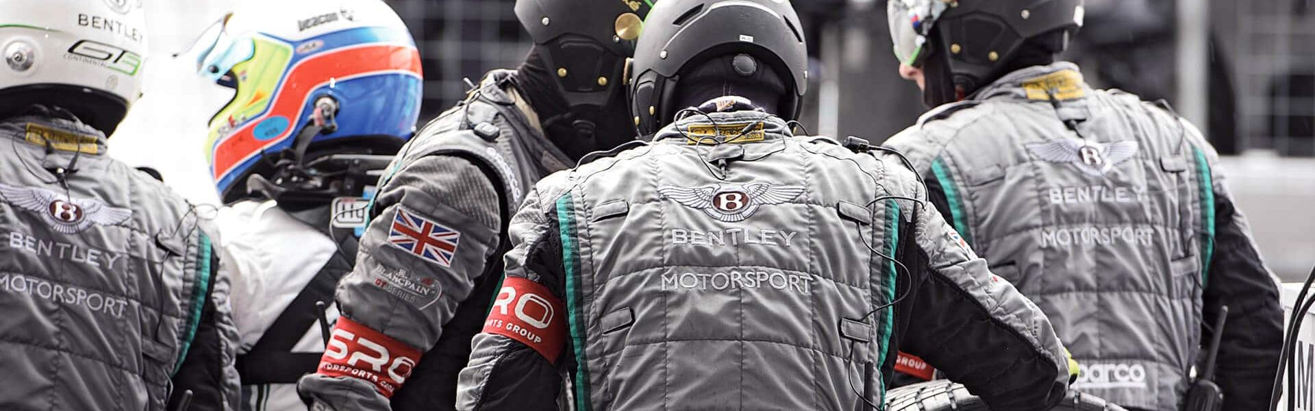 équipe de personnes habillées en gris lors d'une course automobile